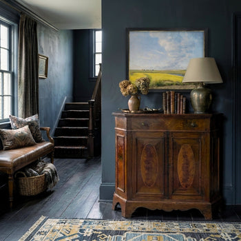 Arthur, an antique hutch is featured in a beautifully styled entryway.  A moody space, painted in dark teal, yet streaming with light from the window.