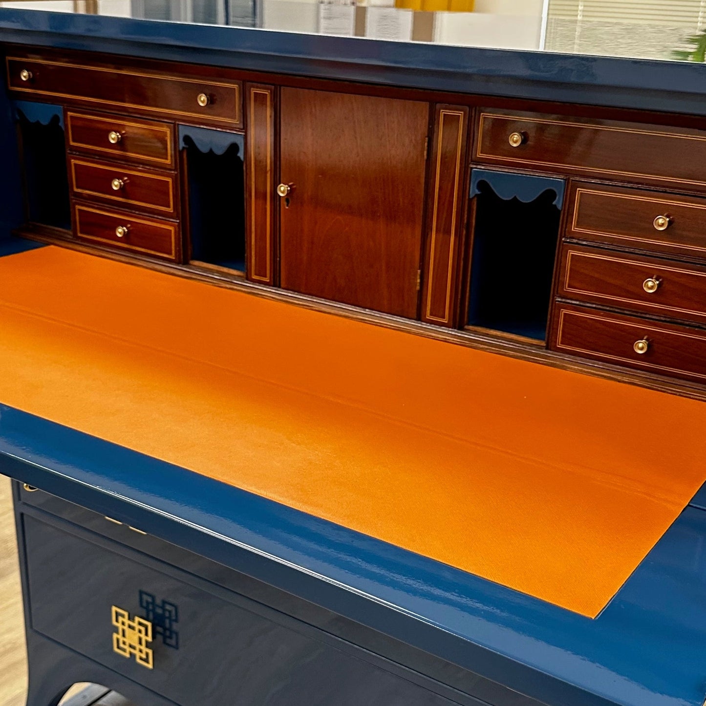 Vintage secretary desk, lacquered in Hidden Sapphire by Benjamin Moore with orange saffiano leather on the interior.