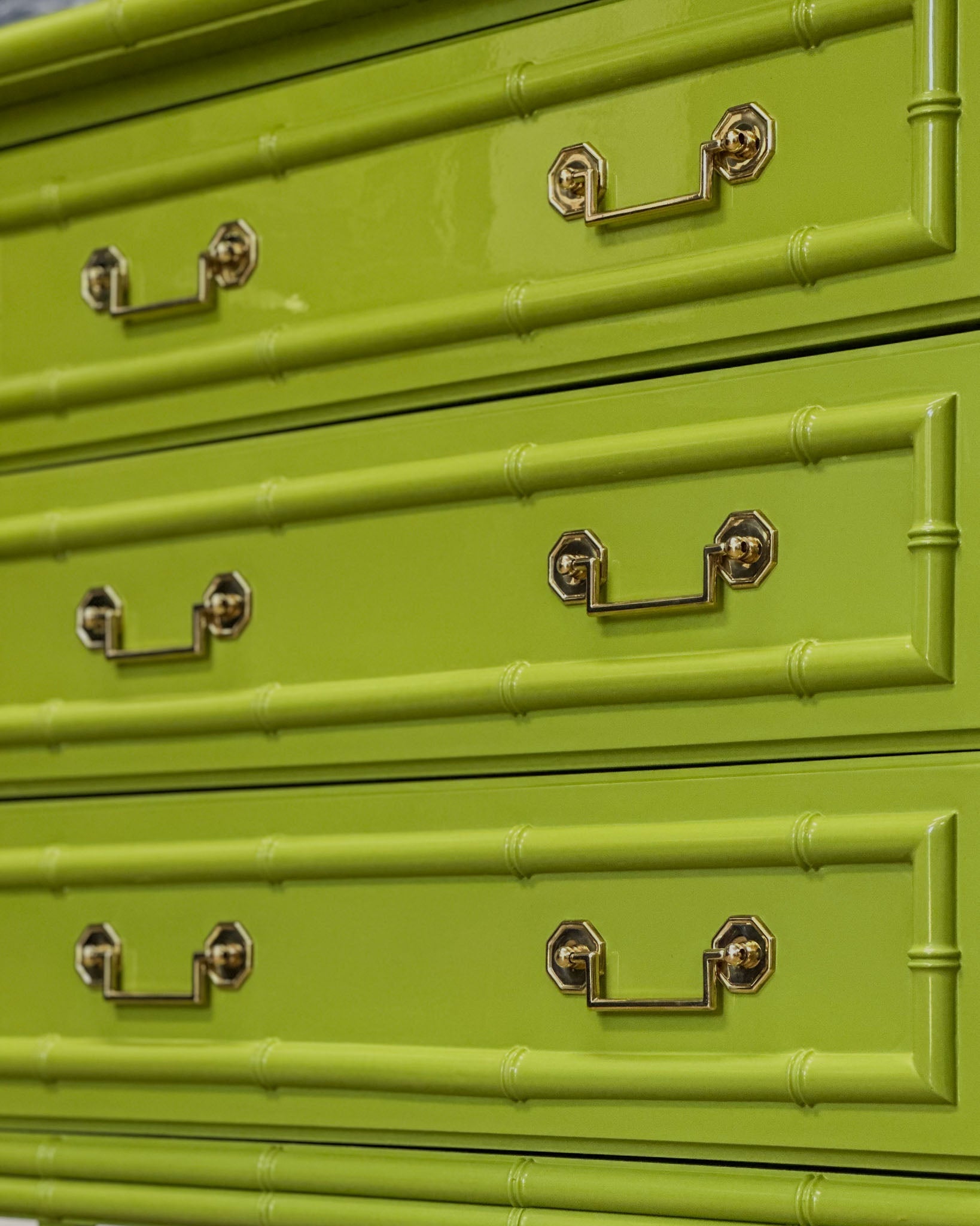 Vintage faux bamboo dresser with upper hutch, refinished in glossy olive green lacquer. Features three drawers and three open shelves with updated vintage-style brass hardware.